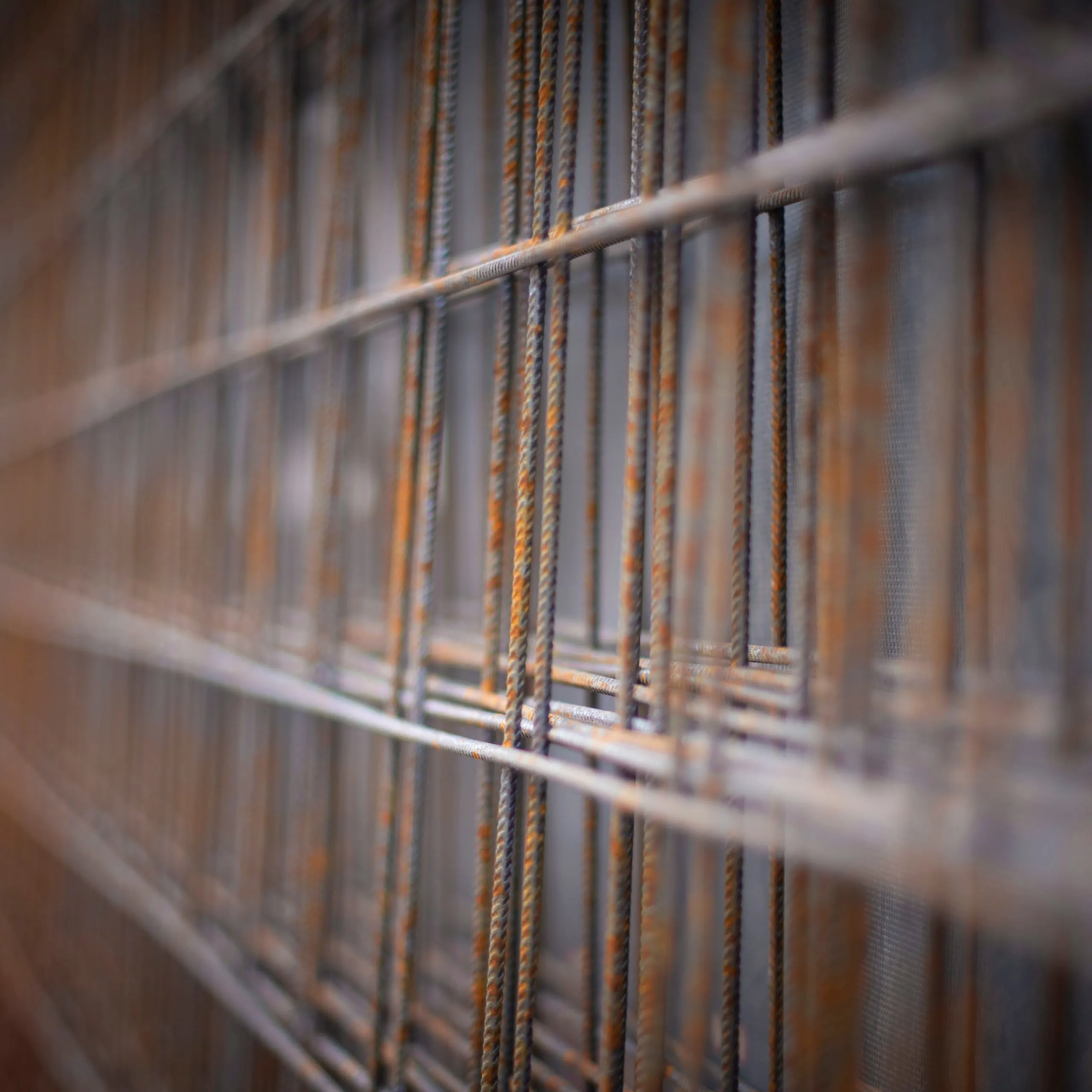 Close-up of rusty reinforcing steel and mesh with soft blur
