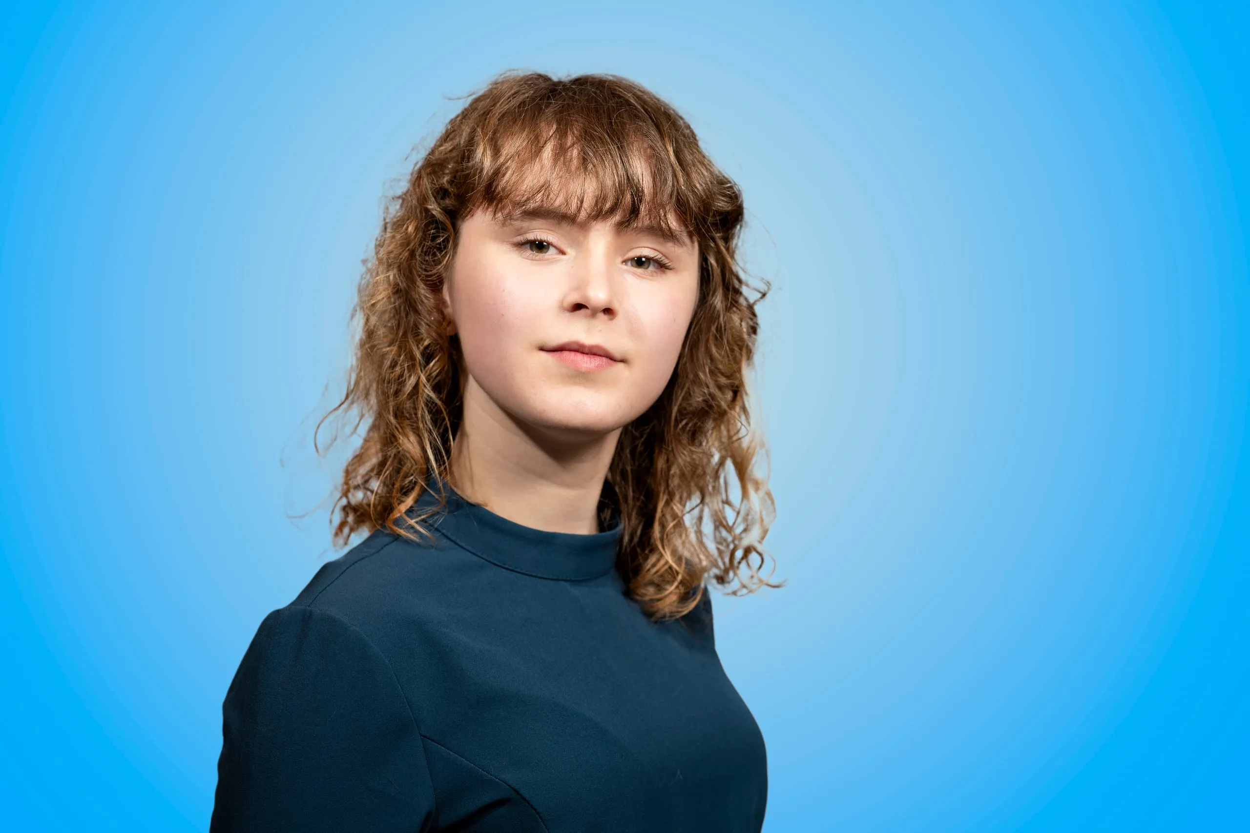 Head-and-shoulders portrait of a young woman with curly hair