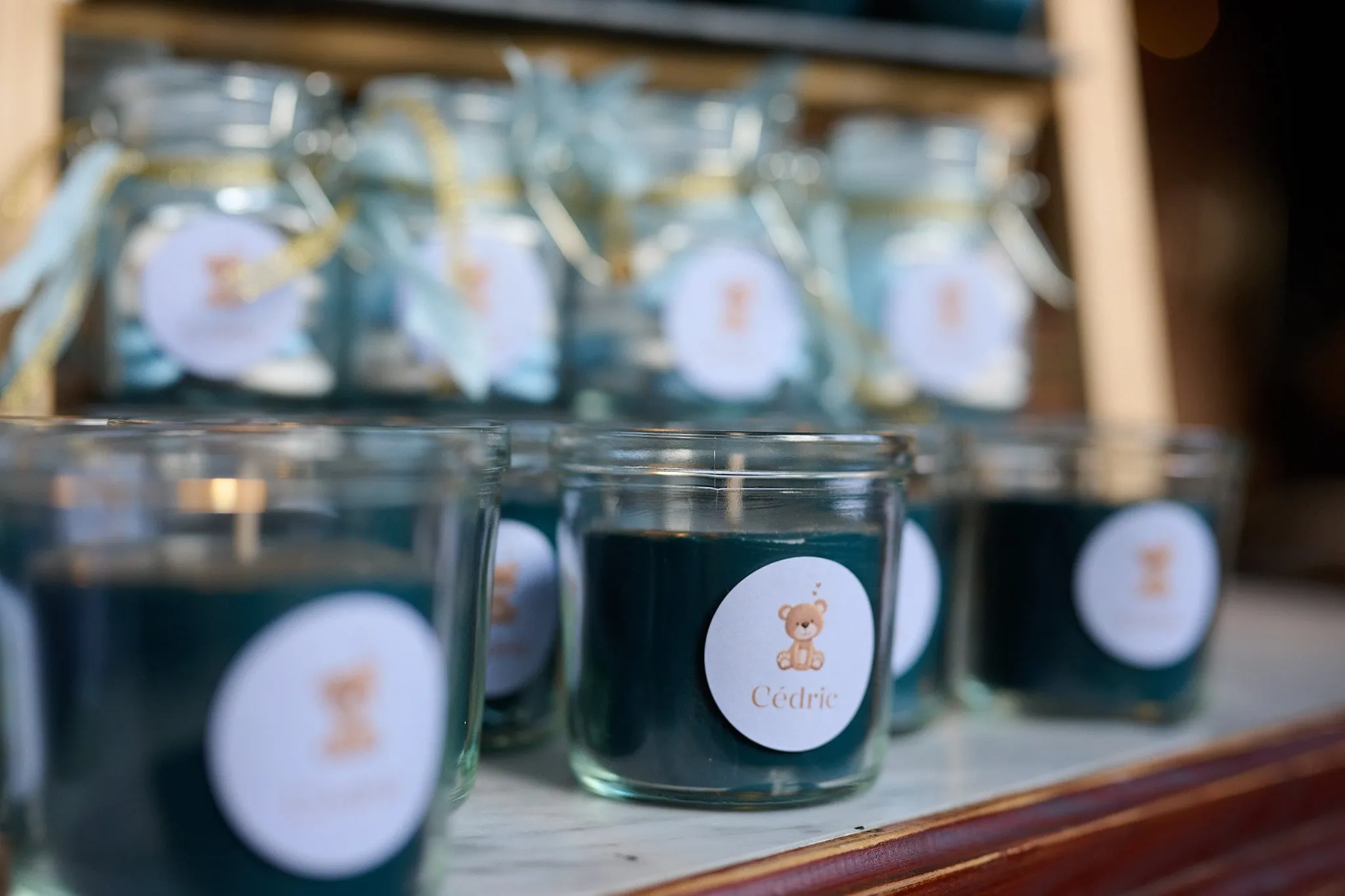 Candles and sweet jars with a label showing a little teddy bear