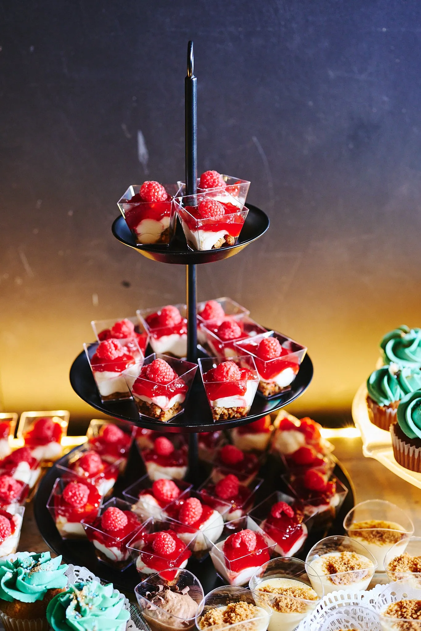 Cake stand with dessert glasses with red fruit