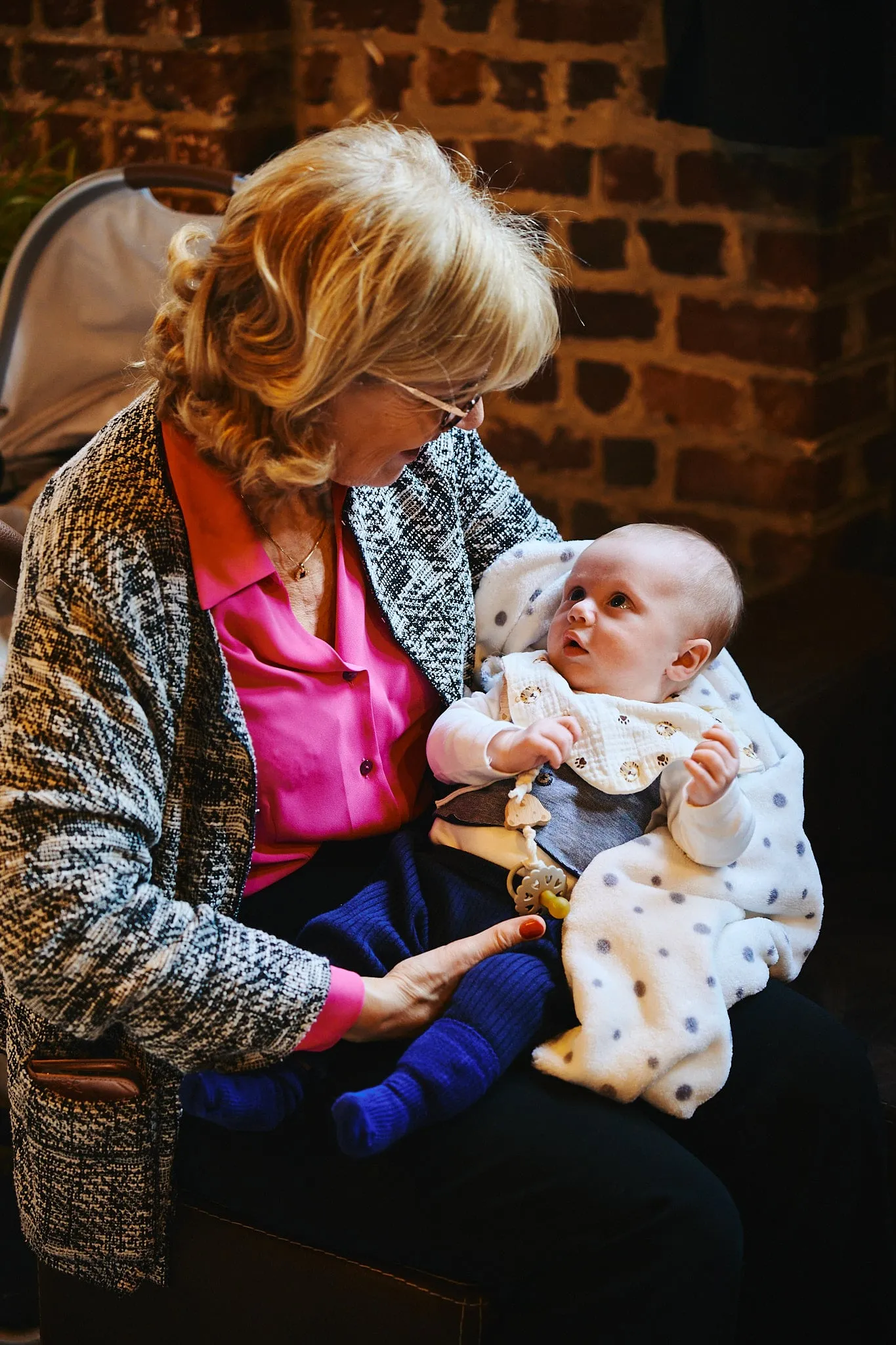 Grandmother with a baby on her lap looking up at her