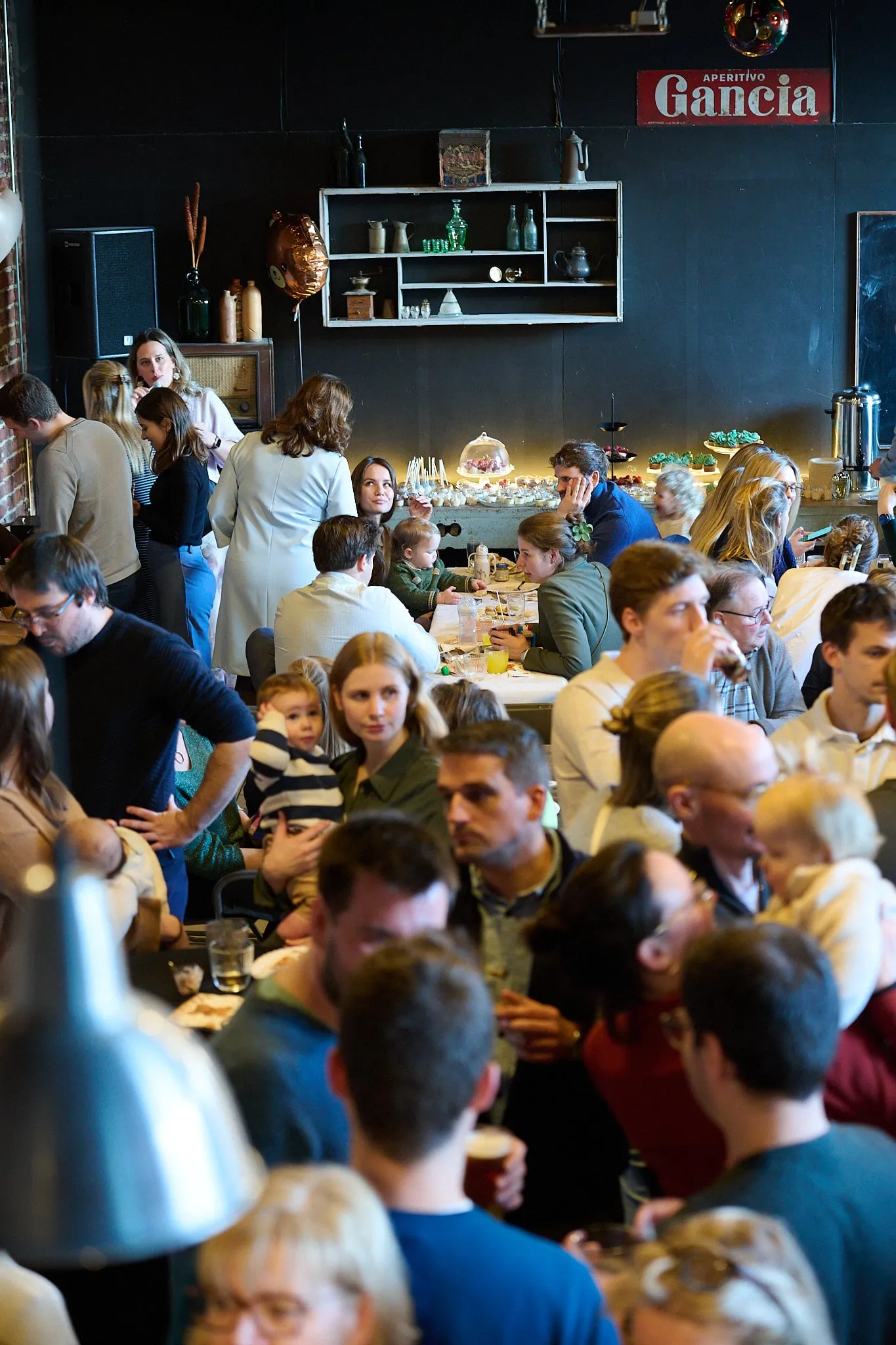 Busy room full of guests at the table, seen from above