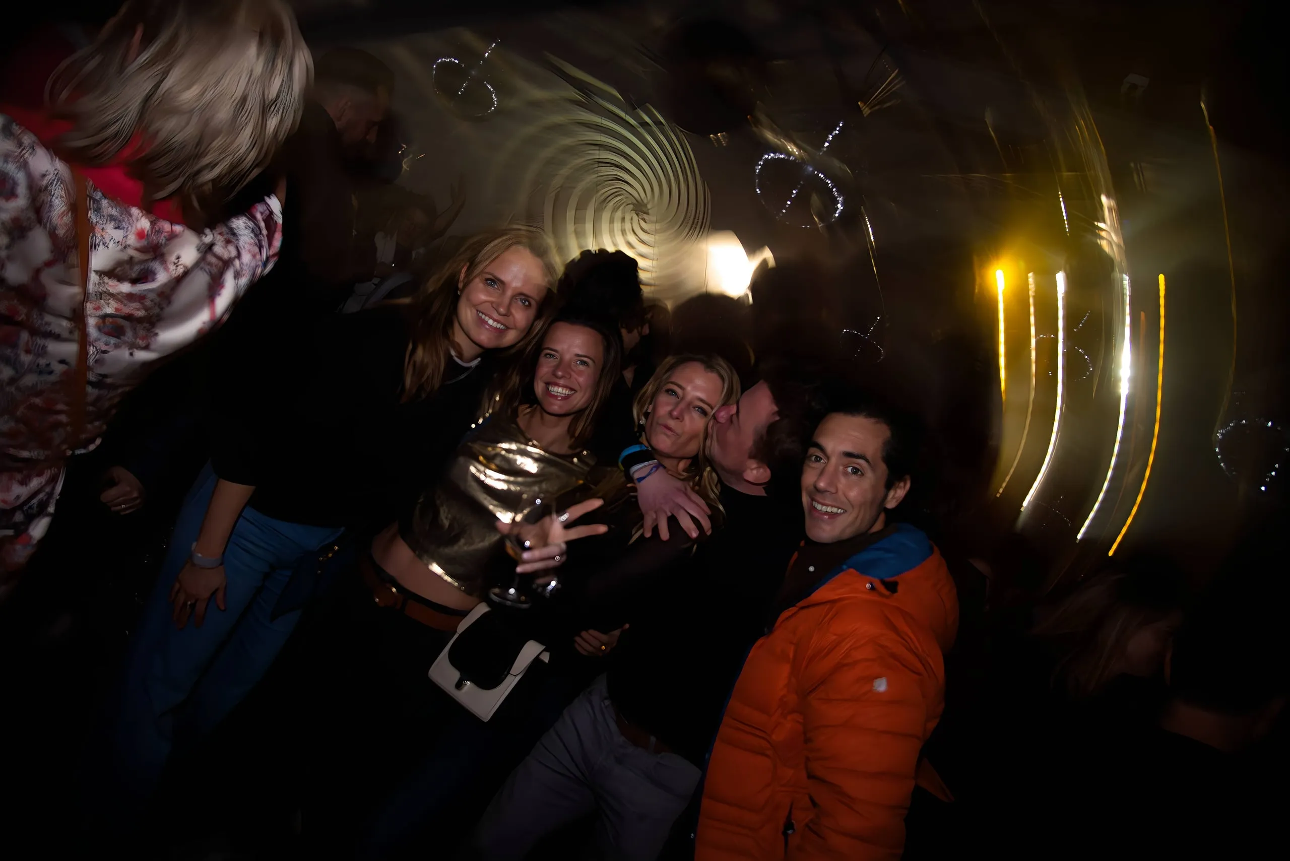 Group of friends posing in the dark with streaks of light in the background