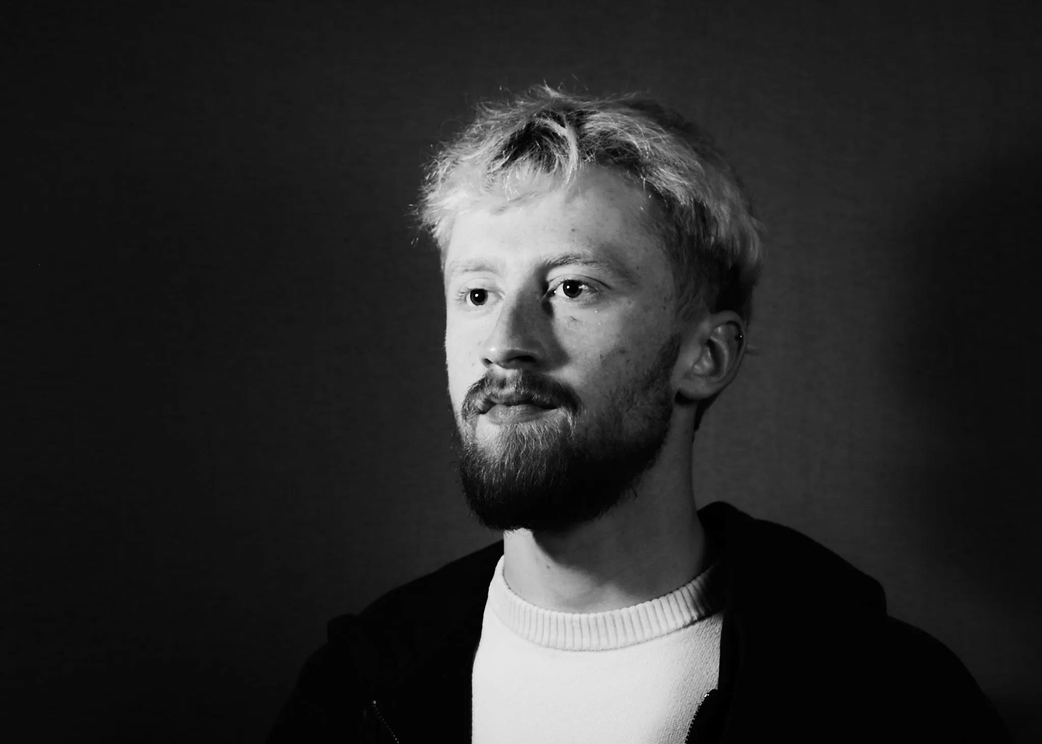 Bearded man looks aside, in black and white