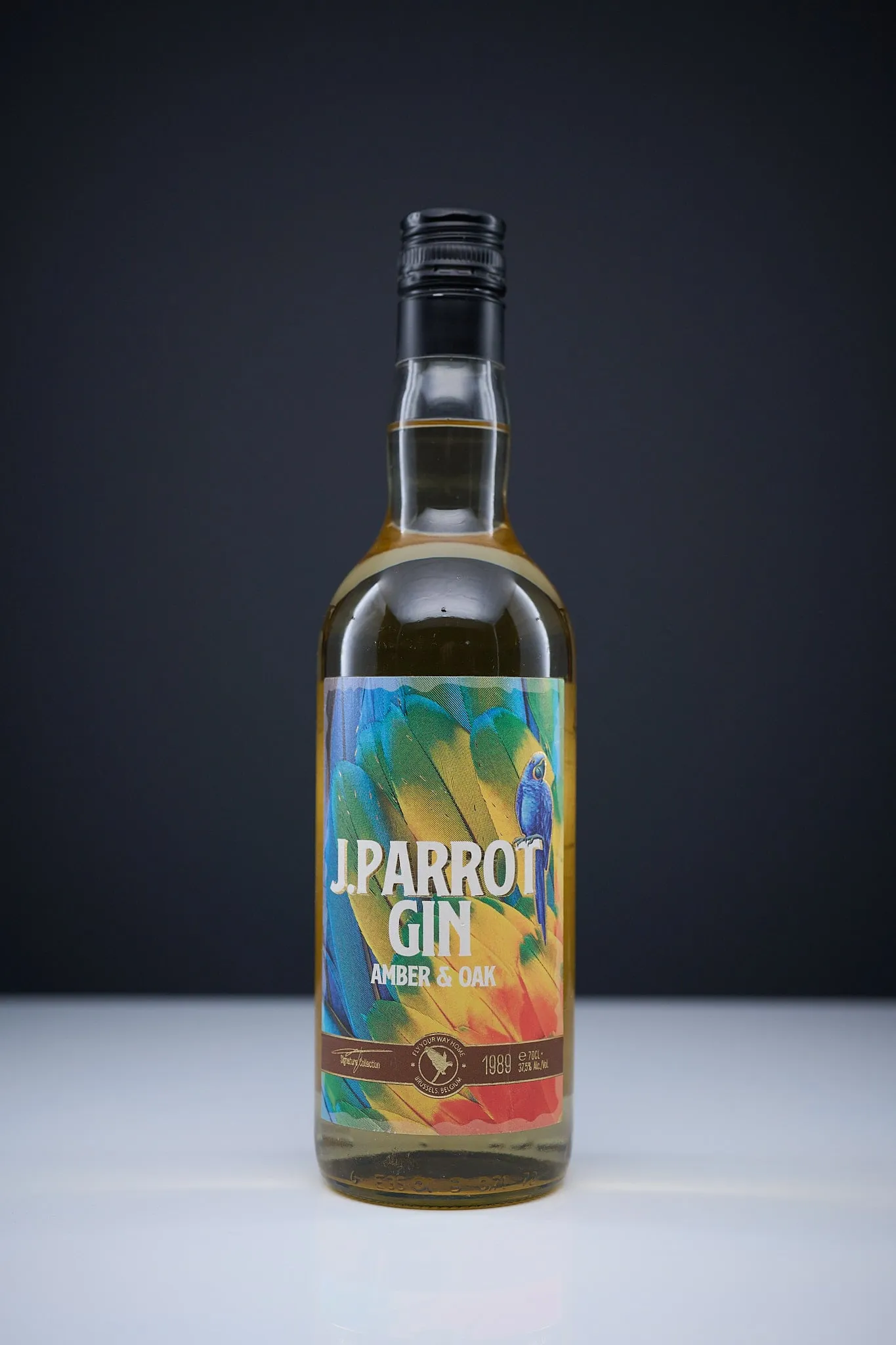 Bottle of J. Parrot Gin Amber & Oak against a dark background